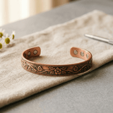 Copper cuff bracelet with hand-engraved flowers and a beaded border