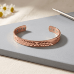 Woman wearing a leaf cut-out copper cuff