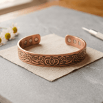 Copper cuff bracelet with a hand-engraved botanical pattern