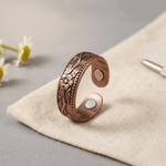 Woman wearing a floral engraved copper ring
