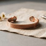 Woman wearing a ridged copper cuff bracelet with hand-cut textured ridges