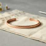 Woman wearing a hammered copper anklet
