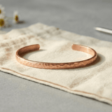 Woman wearing a hammered copper anklet
