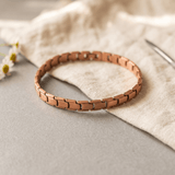 Copper link anklet worn around an ankle