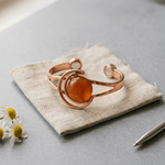 Copper cuff bracelet with a hand-set amber stone