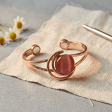 Copper cuff with pink stone inlay