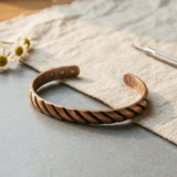 Copper cuff bracelet with a ridged texture and hidden magnets