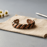 Copper ring with a twisted, ridged texture