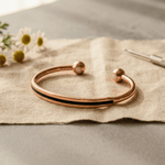 Polished copper cuff with ball-end detail