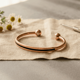 Polished copper cuff with ball-end detail
