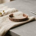 Copper cuff bracelet with hand-engraved vines and flowers