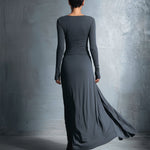 Woman wearing a long-sleeve maxi dress with an adjustable side tie