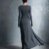 Woman wearing a long-sleeve maxi dress with an adjustable side tie