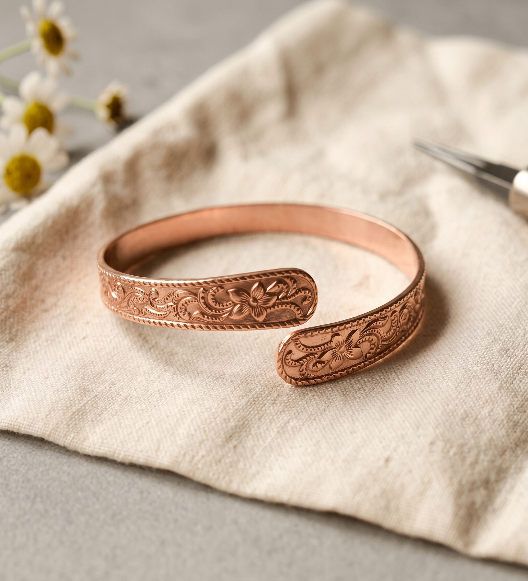 Woman wearing an engraved bypass copper cuff