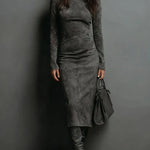 Woman wearing a suede-effect high-neck midi dress