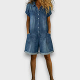 Woman wearing a short vintage cotton jumpsuit with a denim-effect finish