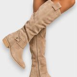 Adelaide beige suede knee-high boots worn, showing side zip